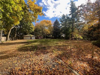 Lot surrounded by beautiful trees, 3-car, brick garage and shed | Image 1