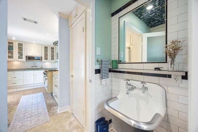 The half bathroom and laundry room share this reclaimed sink. This space functions like a mud room. Not pictured: ample cabinetry for all your household items and spillover storage. | Image 14