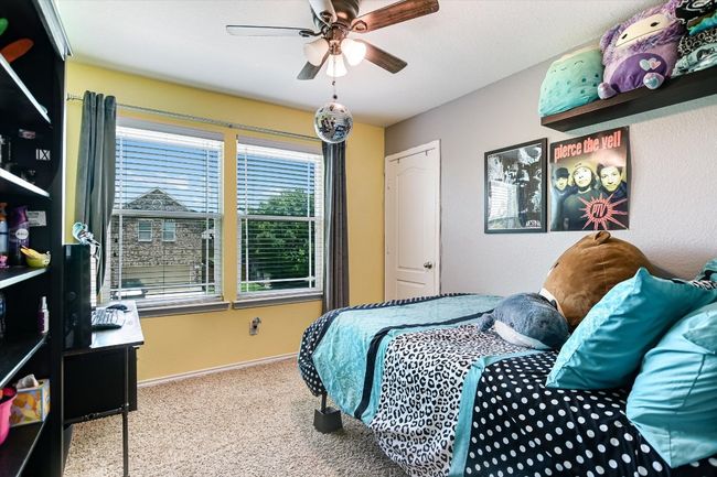 Bedroom with carpet flooring, baseboards, and a ceiling fan | Image 23