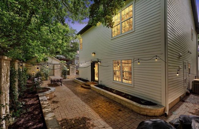 View of home's exterior with fence and a patio | Image 5