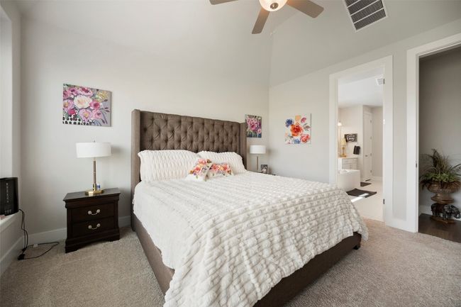 Carpeted bedroom with ceiling fan and vaulted ceiling | Image 24