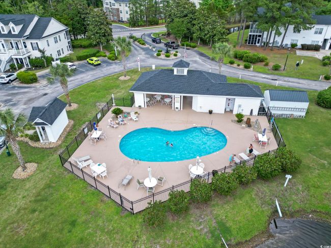 Pool with a yard, a water slide, fence, and a patio area | Image 29