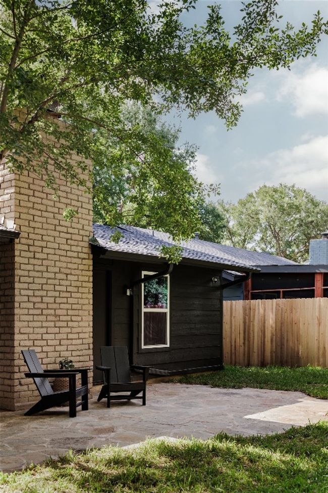 Rear view of house with a patio and a chimney | Image 32