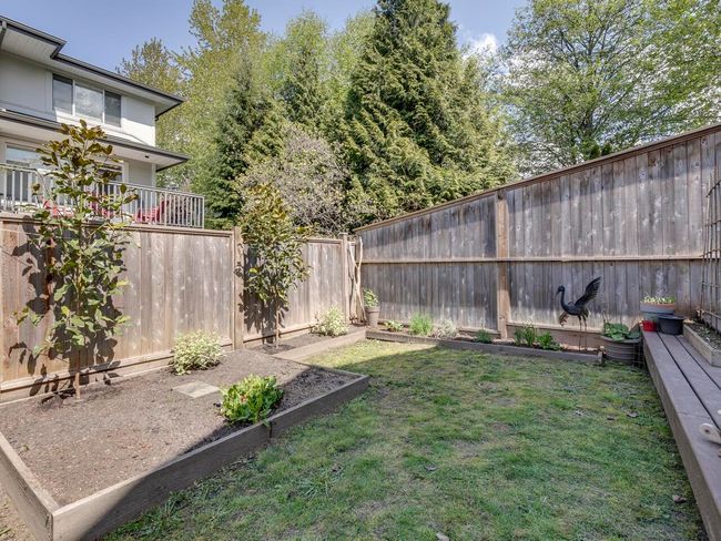 View of yard featuring a fenced backyard and a vegetable garden | Image 34