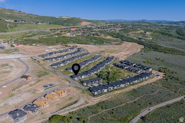 Aerial view of property's location featuring a mountain backdrop and nearby suburban area | Image 42