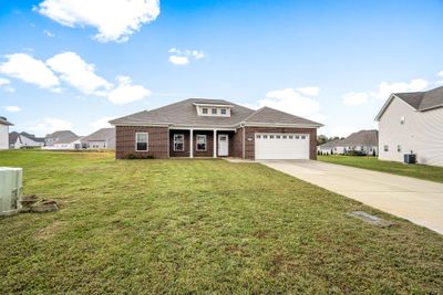 This craftsman style home has maximum curb appeal with a stately brick front and is so easy to maintain with vinyl siding on the other 3 sides. | Image 2