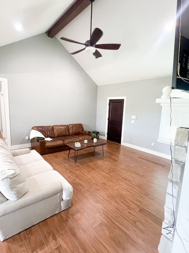Living room featuring hardwood / wood-style floors, ceiling fan, and lofted ceiling with beams | Image 6