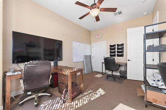 Office area with baseboards, visible vents, carpet flooring, and a ceiling fan | Image 15