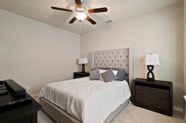 Bedroom with carpet flooring, baseboards, and a ceiling fan | Image 35