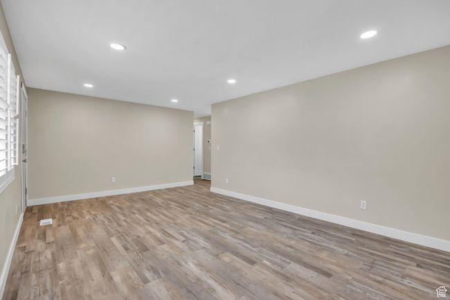 Unfurnished room featuring light wood-type flooring, baseboards, visible vents, and recessed lighting | Image 10