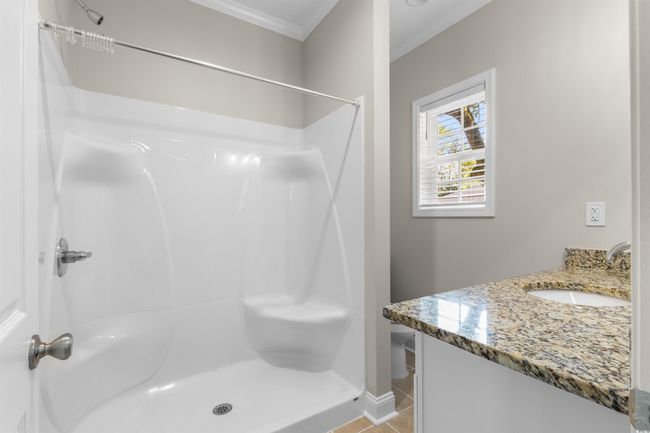 Full bathroom featuring ornamental molding, vanity, a shower, tile patterned floors, and baseboards | Image 16