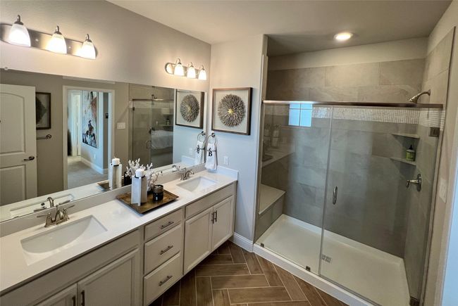 Full bath featuring a shower stall, double vanity, and recessed lighting | Image 19