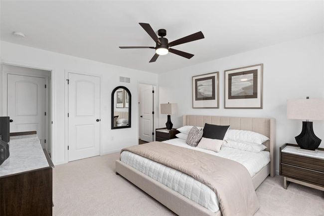Bedroom featuring ceiling fan and light colored carpet | Image 23