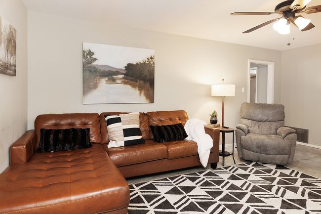 Living area with ceiling fan, baseboards, and visible vents | Image 15