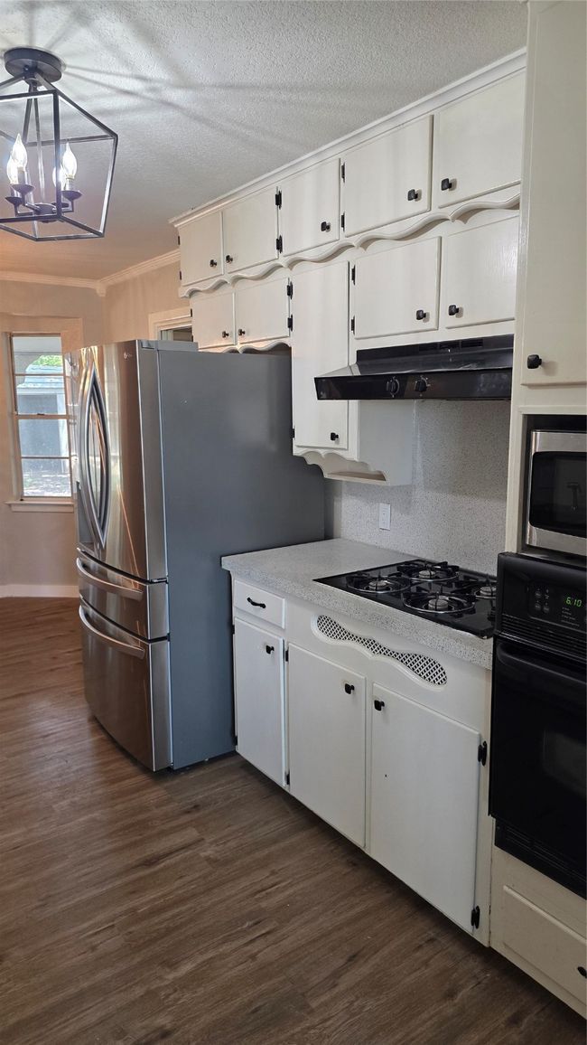 Kitchen featuring an abundance of storage and refinished counters. | Image 4