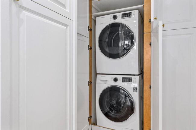 Laundry area featuring estacked washer and dryer | Image 21
