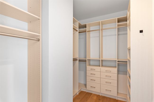 Spacious closet with light wood-style flooring | Image 17