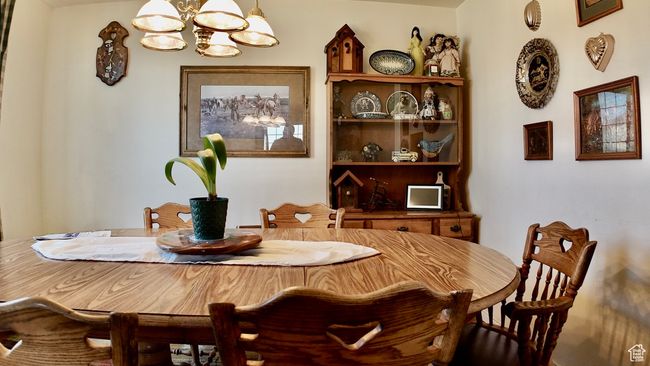 Dining area featuring a notable chandelier | Image 59