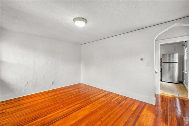 Tiled empty room featuring a textured ceiling | Image 17