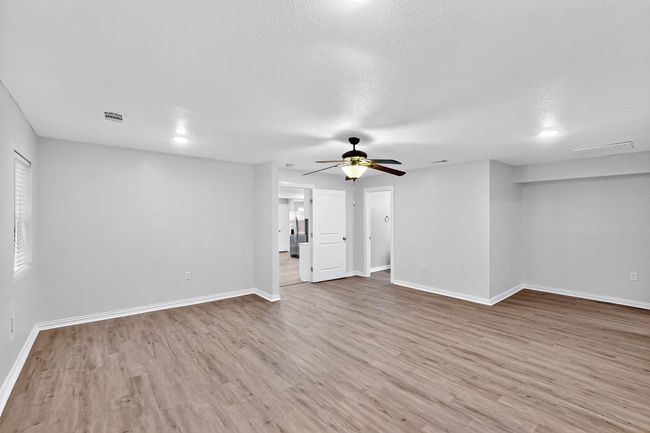 Unfurnished living room featuring wood finished floors and a ceiling fan | Image 30