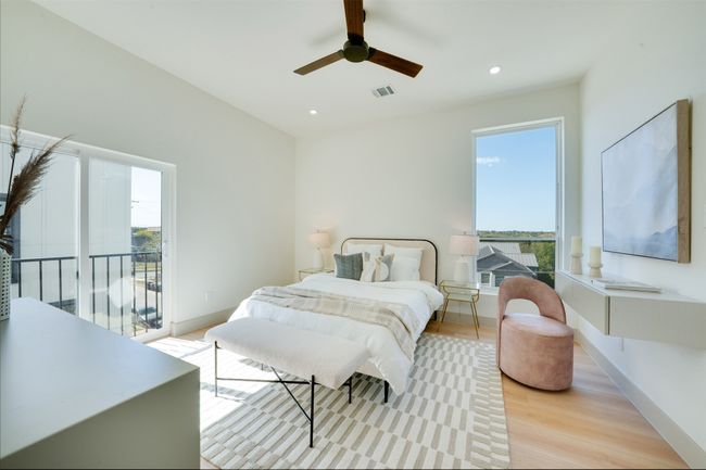 Bedroom featuring access to outside, multiple windows, light hardwood / wood-style floors, and ceiling fan | Image 18