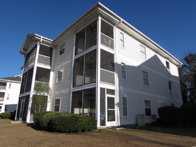 Back of house featuring screen porch. | Image 5