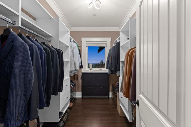 Walk in closet featuring dark wood-style flooring | Image 22
