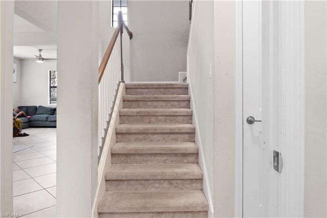 Staircase with tile patterned floors and a ceiling fan | Image 16