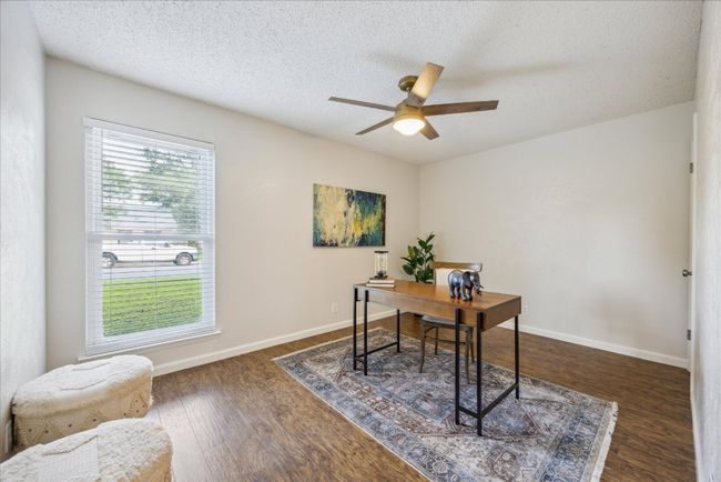 Office space with a ceiling fan, dark wood-style floors, and a textured ceiling | Image 21