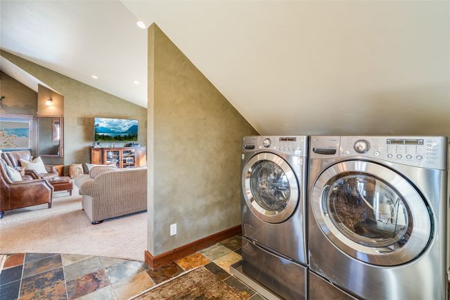 Caretaker Quarters / Guest House. Washroom with washing machine and clothes dryer, baseboards, laundry area, recessed lighting, and stone tile flooring | Image 88