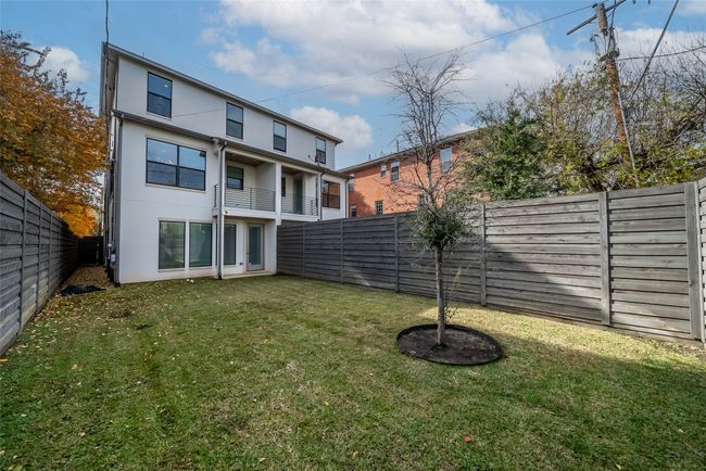 Rear view of property featuring stucco siding and a fenced backyard | Image 35