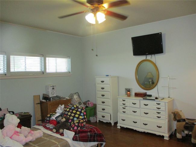 Bedroom with dark hardwood / wood-style floors and ceiling fan | Image 25