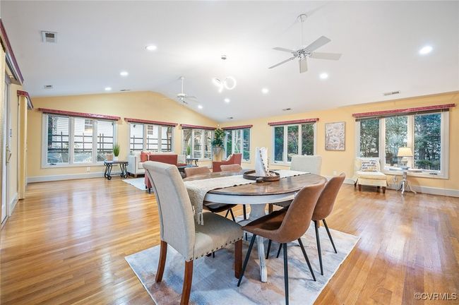 This 29' x 23' Florida room open space with vaulted ceilings, a built-in wet bar, three French doors, and warm hardwoods | Image 20