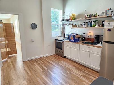 Unfurnished living room featuring light hardwood / wood-style flooring and a wealth of natural light | Image 2