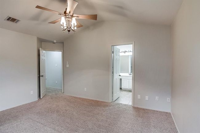 Unfurnished room featuring ceiling fan, light carpet, vaulted ceiling, and baseboards | Image 20