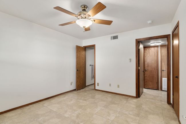 Unfurnished bedroom featuring baseboards, visible vents, and ceiling fan | Image 30