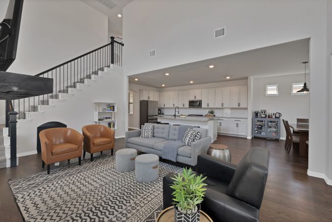Living room featuring stairs, dark wood-type flooring, baseboards, visible vents, and recessed lighting | Image 16