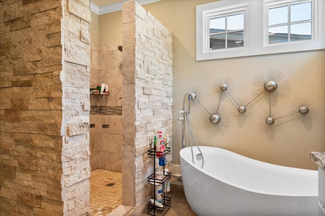 Bathroom with a freestanding bath, walk in shower, and crown molding | Image 17