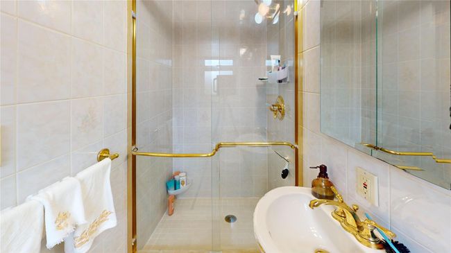 Bathroom with a shower stall and tile walls | Image 17