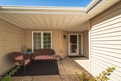 The covered front patio is an inviting place to greet neighbors or enjoy the afternoon shade. | Image 3