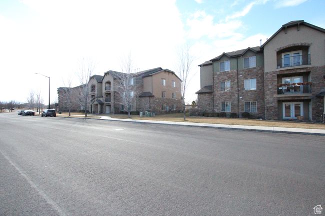 View of street featuring curbs, sidewalks, and street lights | Image 21