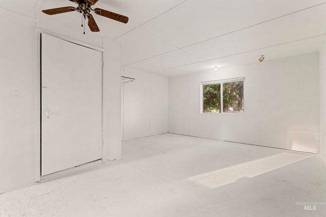 Unfurnished bedroom featuring concrete flooring and ceiling fan | Image 22