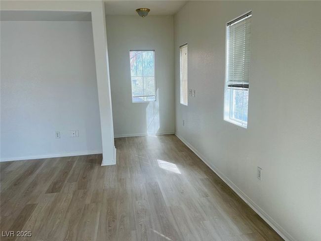 Empty room with wood finished floors and baseboards | Image 11