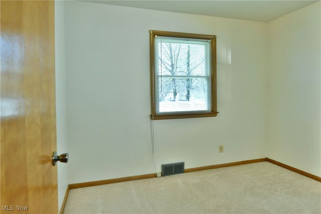 Carpeted spare room featuring baseboards and visible vents | Image 26