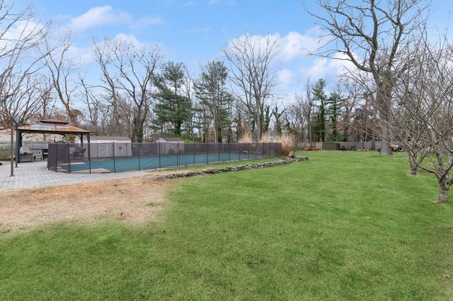View of pool featuring a gazebo, a patio area, fence, and a lawn | Image 28