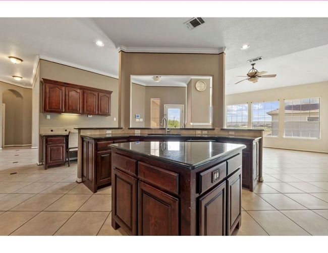 Kitchen with a center island, a peninsula, light tile patterned floors, plenty of natural light, and recessed lighting | Image 18