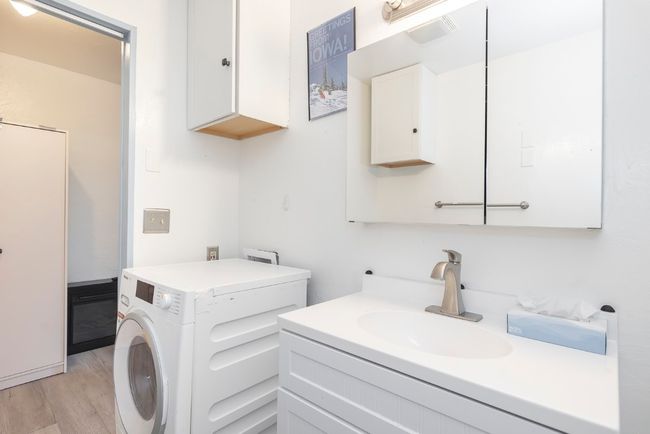 Bathroom with washer / clothes dryer, wood finished floors, and vanity | Image 6
