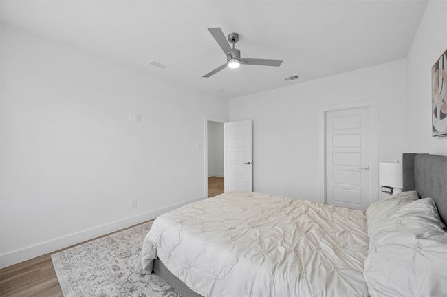 Bedroom featuring wood finished floors and a ceiling fan | Image 18