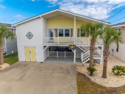 View of front of property with covered porch and a carport | Image 1