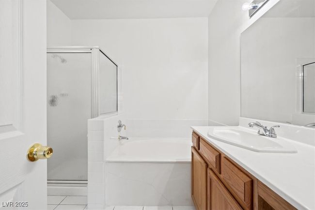 Full bath with vanity, a shower stall, a bath, and tile patterned floors | Image 16